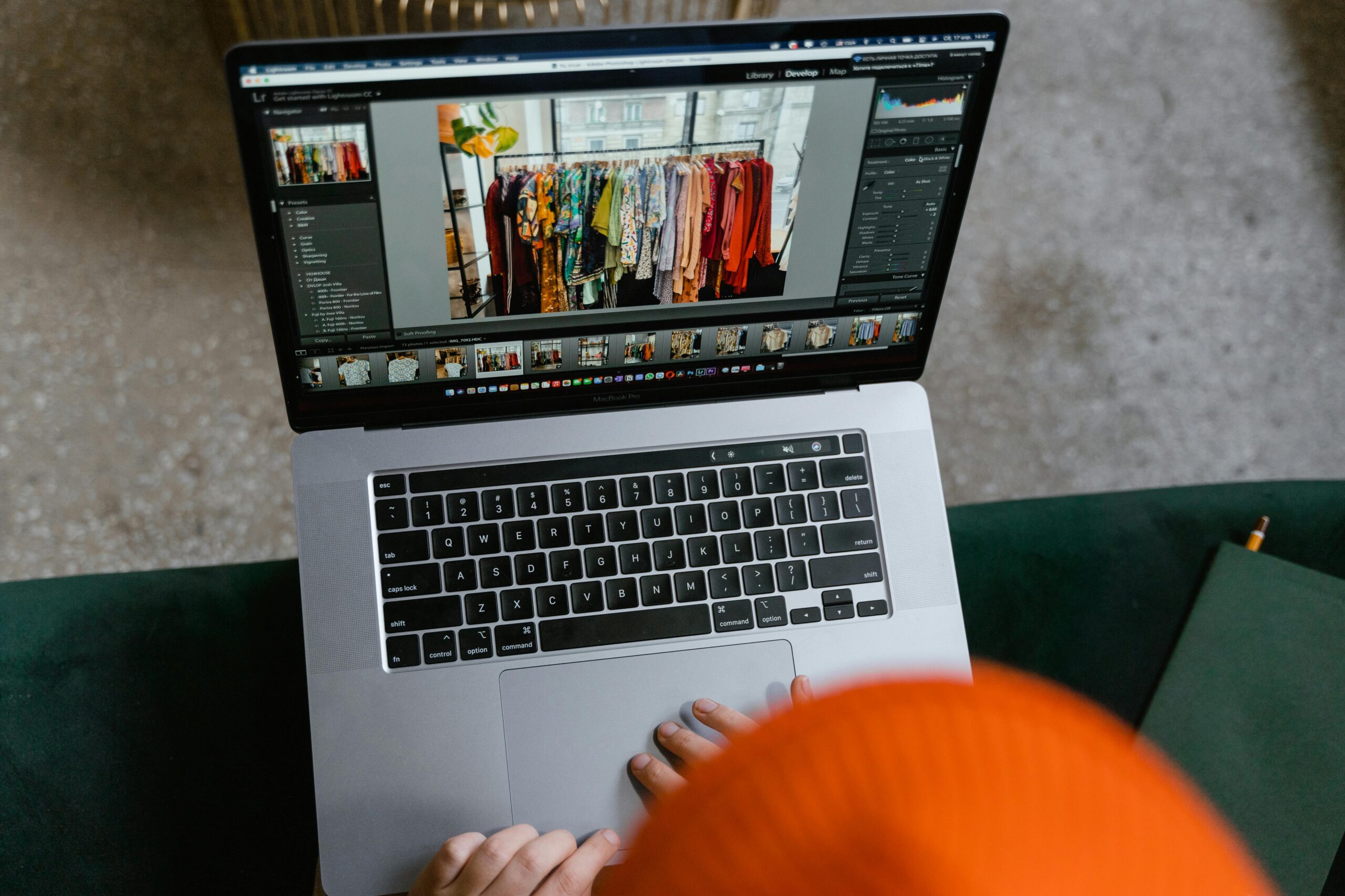A person in a cozy setting edits photos of clothing displays on a laptop, Top 5 Platforms to Sell Digital Products in 2025